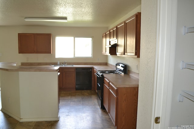 kitchen featuring black appliances, sink, and a textured ceiling