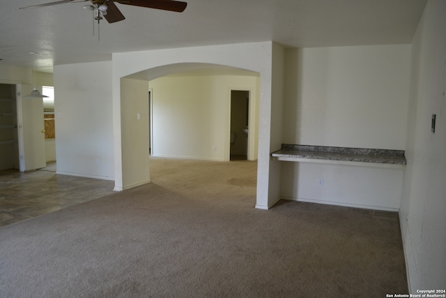 spare room featuring carpet and ceiling fan