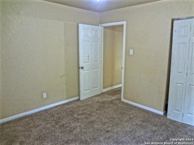 unfurnished bedroom with baseboards and carpet floors