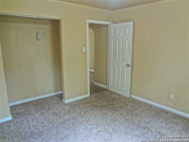 unfurnished bedroom featuring baseboards and carpet floors