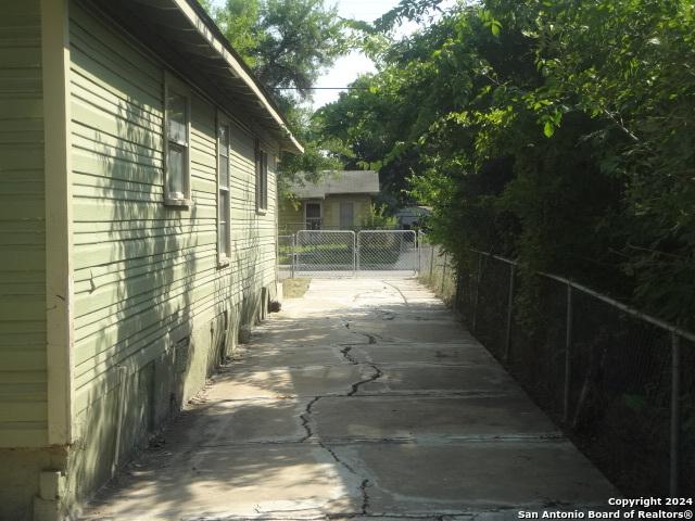 view of side of home with a patio area and fence