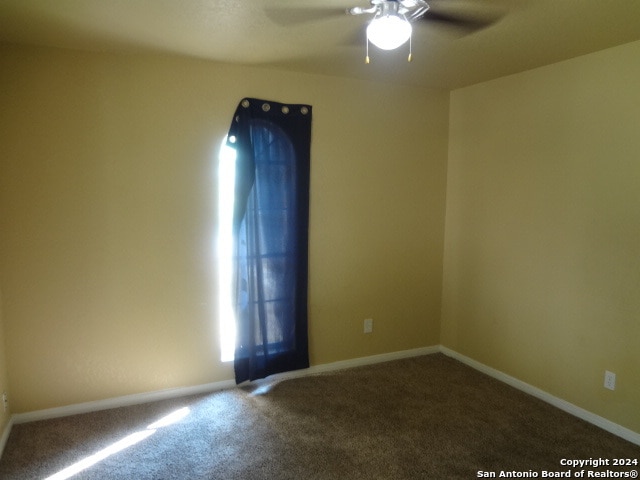 carpeted empty room with ceiling fan