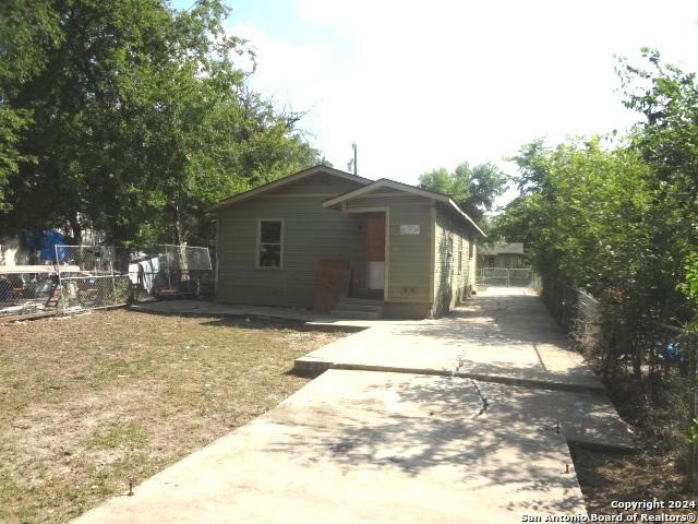 bungalow-style house with fence