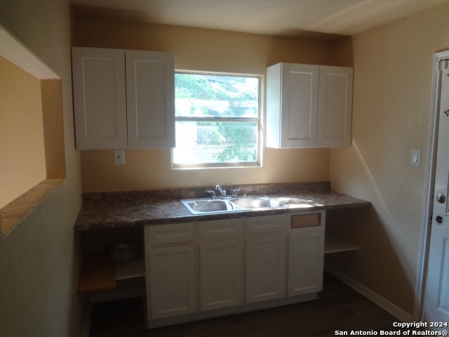 kitchen featuring sink and white cabinetry