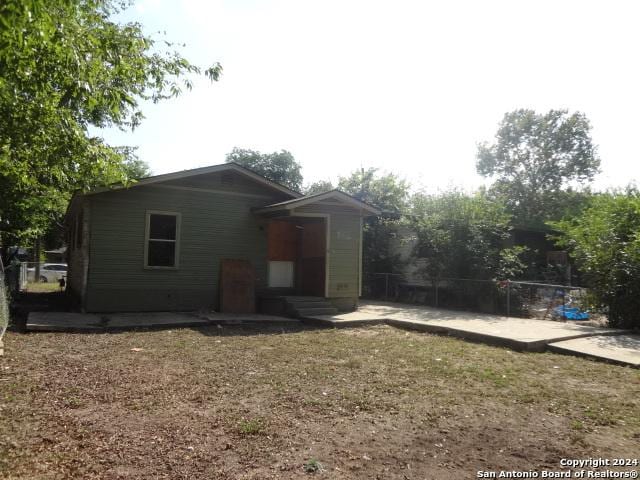 rear view of property with entry steps and a patio