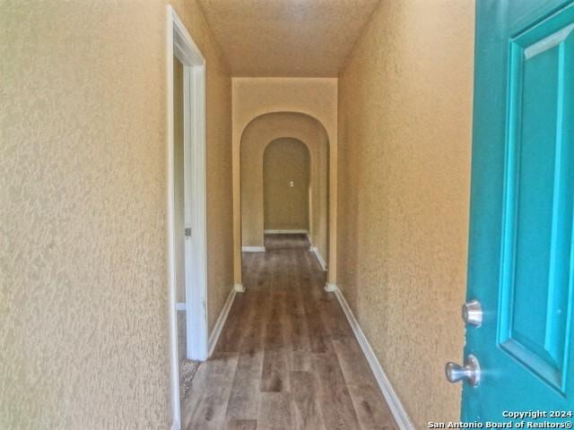 corridor featuring arched walkways