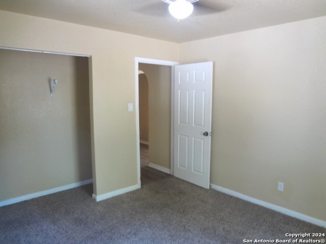 unfurnished bedroom with ceiling fan and carpet