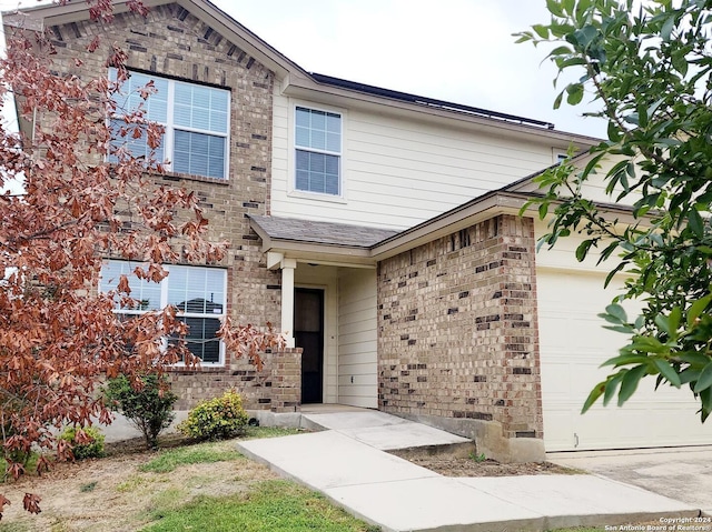 traditional-style home with brick siding and an attached garage