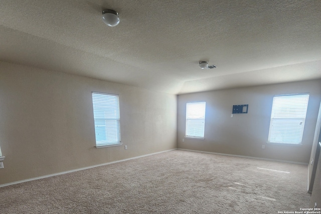 carpeted spare room featuring a textured ceiling