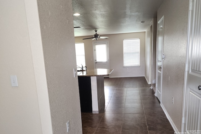 hallway with dark tile patterned floors