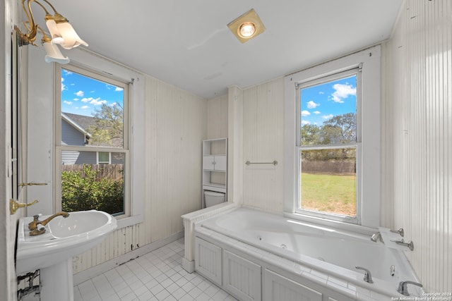 bathroom with a tub and tile patterned floors