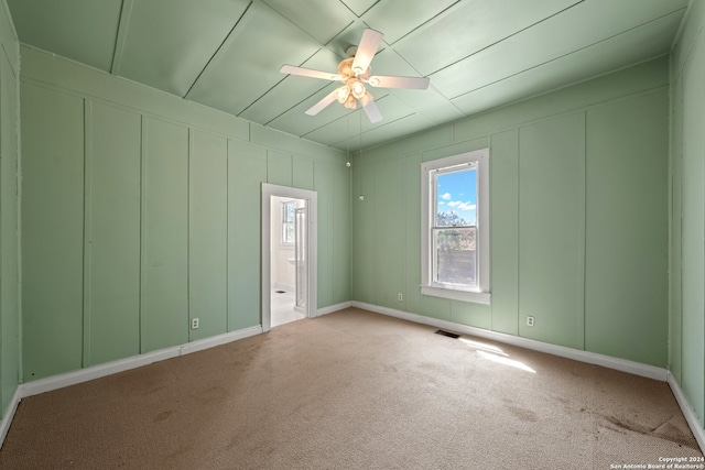 unfurnished room with ceiling fan and carpet floors