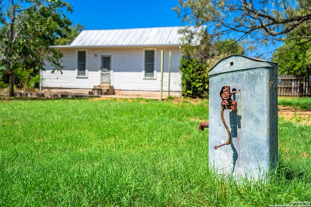 exterior space with a storage shed and a front yard