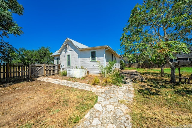 view of home's exterior with a yard