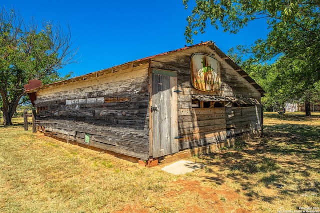 view of outdoor structure featuring a lawn