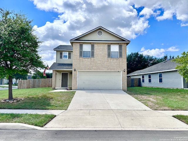 front of property with a front yard and a garage