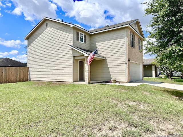 front of property featuring a front yard and a garage