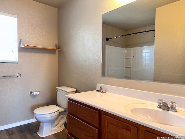 bathroom with walk in shower, wood-type flooring, vanity, and toilet