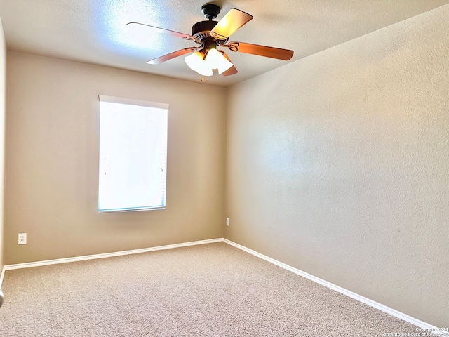 spare room with carpet, ceiling fan, and a textured ceiling