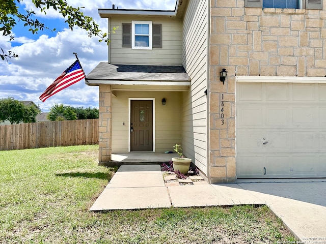 view of front of house with a front yard and a garage