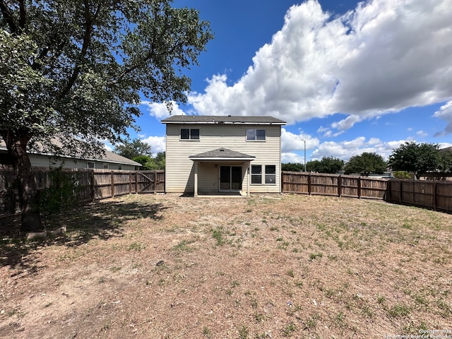 back of property with a lawn