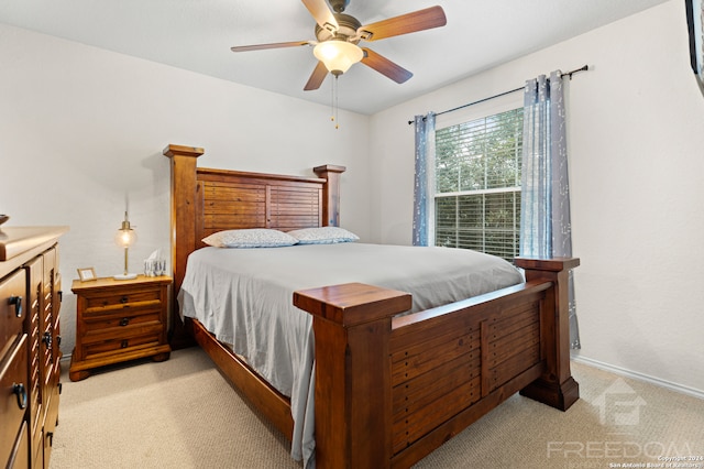 bedroom with ceiling fan and light colored carpet