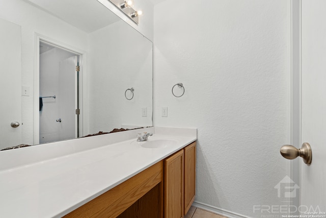 bathroom with tile patterned floors and vanity