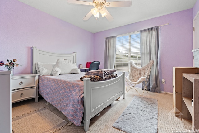 bedroom featuring ceiling fan and light carpet