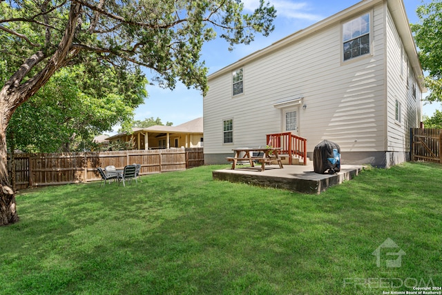 back of property featuring a lawn and a patio