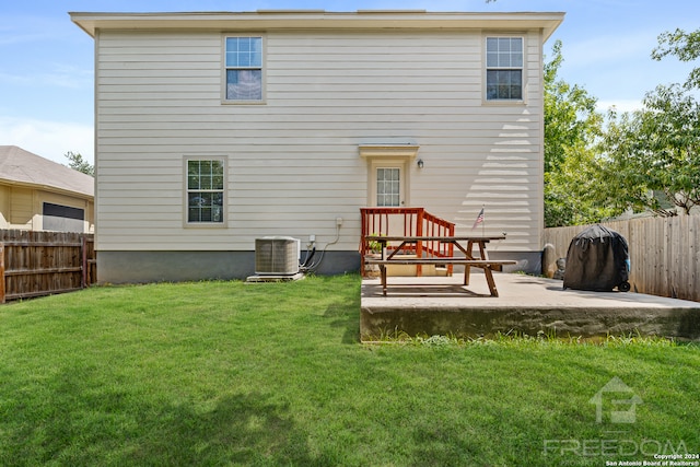 back of property featuring a patio, central AC, and a lawn