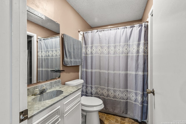 bathroom featuring curtained shower, toilet, a textured ceiling, and vanity