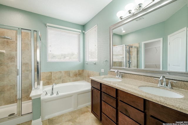 bathroom featuring vanity, independent shower and bath, and tile patterned floors