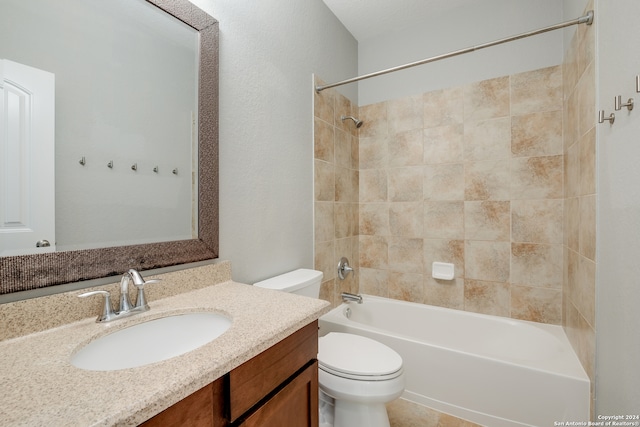 full bathroom featuring tiled shower / bath combo, vanity, toilet, and tile patterned flooring