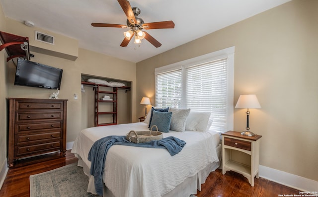 bedroom with ceiling fan and dark hardwood / wood-style flooring