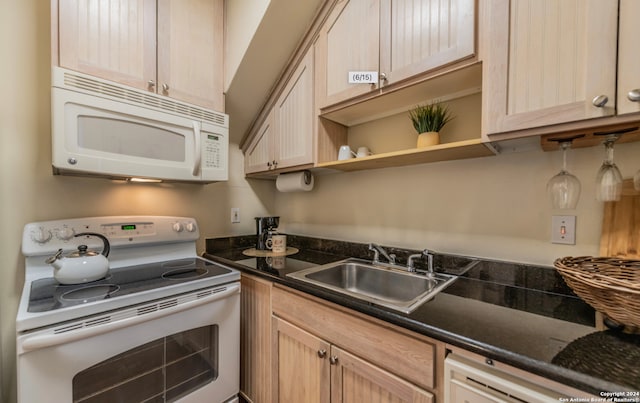 kitchen featuring white appliances, light brown cabinets, and sink