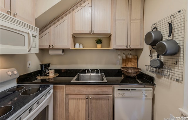 kitchen featuring sink, light brown cabinets, and white appliances