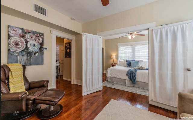 bedroom with ceiling fan and dark hardwood / wood-style floors