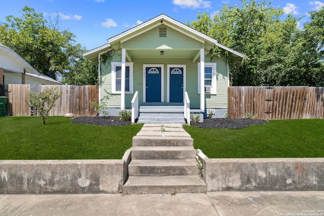 bungalow-style home with a front lawn