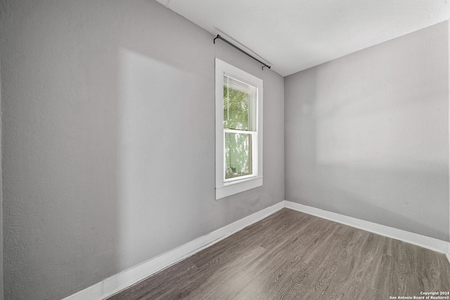 empty room with hardwood / wood-style floors