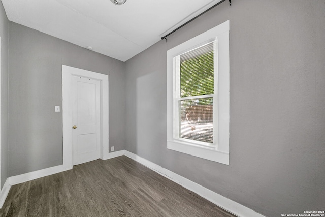 143 Paul St, San Antonio, TX 78203 - spare room with baseboards and dark wood-type flooring