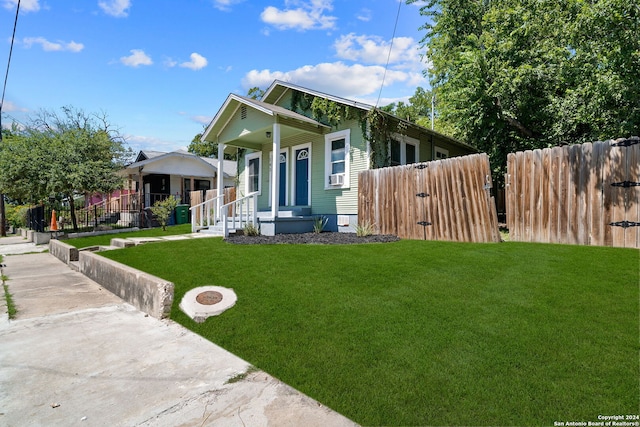 view of front of house with covered porch and a front yard