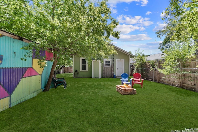 143 Paul St, San Antonio, TX 78203 - view of yard with fence, an outbuilding, and an outdoor fire pit