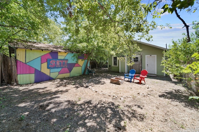 rear view of house featuring a fire pit