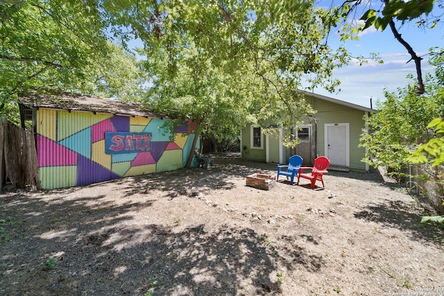 143 Paul St, San Antonio, TX 78203 - back of house with an outdoor fire pit and an outbuilding