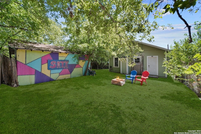 143 Paul St, San Antonio, TX 78203 - view of yard with an outdoor structure and an outdoor fire pit