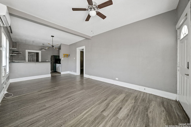 143 Paul St, San Antonio, TX 78203 - unfurnished living room featuring dark wood-style flooring, an AC wall unit, baseboards, and ceiling fan