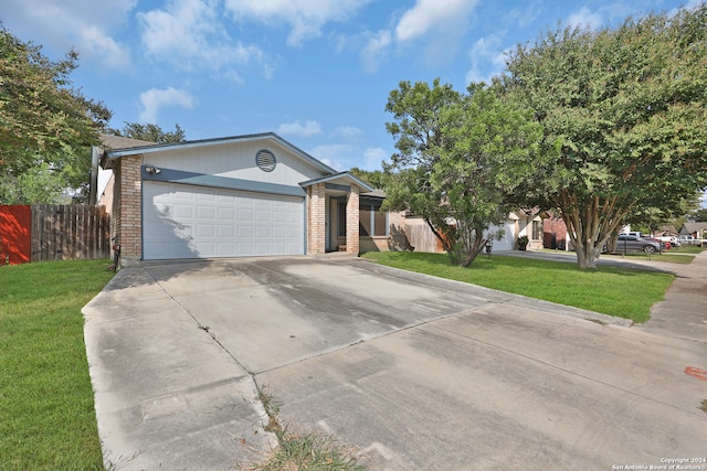 ranch-style house featuring a garage and a front lawn