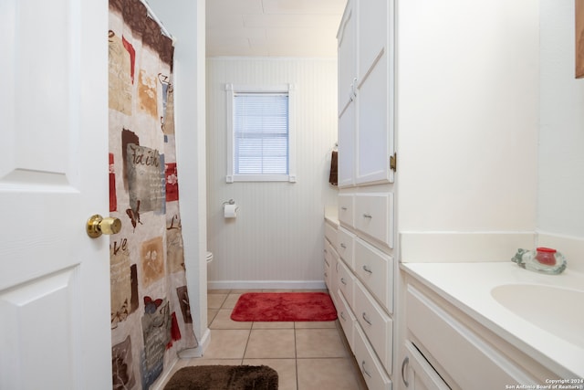 bathroom featuring vanity, crown molding, a shower with shower curtain, toilet, and tile patterned floors