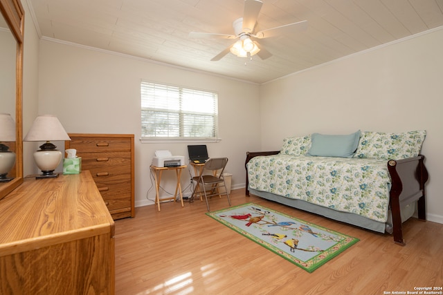 bedroom featuring ceiling fan, hardwood / wood-style floors, and crown molding