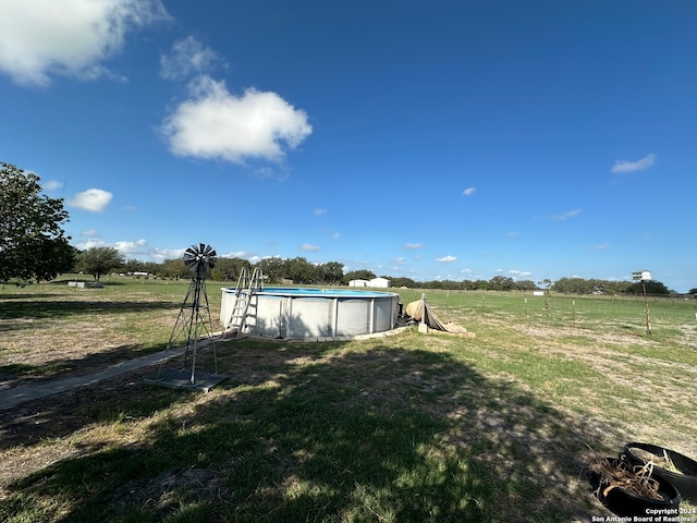 view of yard with a rural view